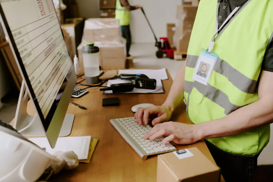 Warehouse worker using a rubber stamp on business paperwork
